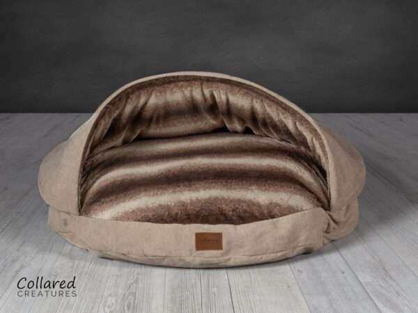 product shot of collared creatures luxury beige cave bed