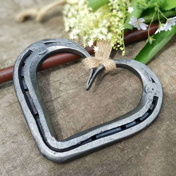 original horseshoe hearts equestrian gift Our Original Horseshoe Heart. Skilfully hand forged from one whole used horseshoe. Crafted with care to retain wear marks and character of it's old form combined with simple, clean lines of the new. Hand stamped personalisation is available on the arches of the heart, for names, dates or phrase to make your heart extra special and unique to you. Please use the top personalistion box for the Left Arch of Heart and use the bottom personalisation box for the Right Arch of Heart