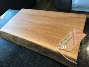small chopp1 1 Hardwood chopping board approx 30-40cm wide x 20-25cm deep x 3-6cm thick. Natural waney edge. Oak/elm/ash/beech/cherry