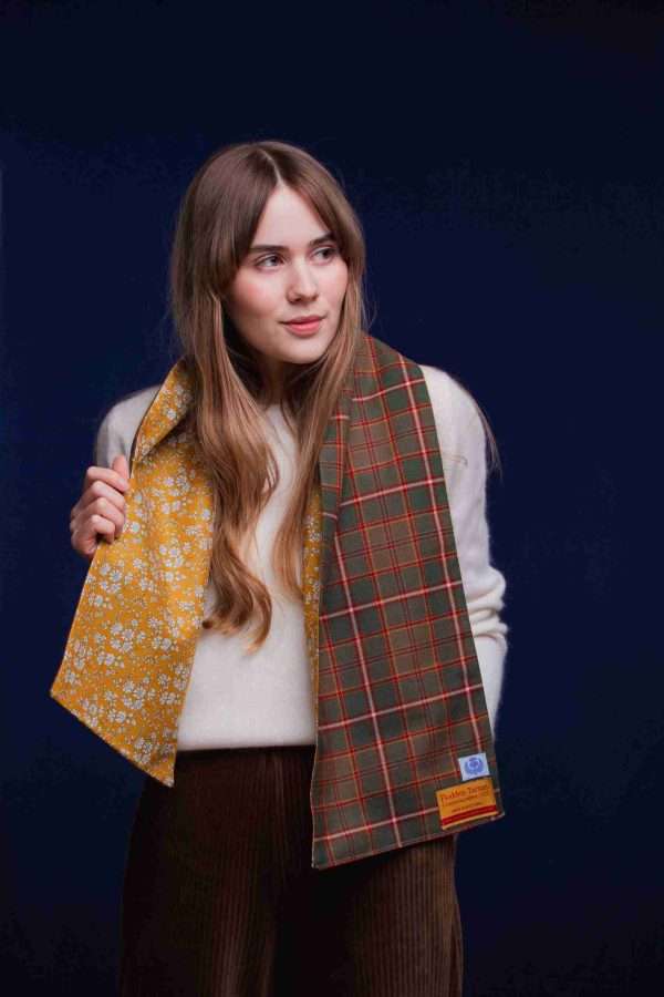 LoullyMakes Studio 4 39 scaled Classic Long scarf in our own exclusive Flodden Commemorative tartan with Liberty Print tana lawn cotton lining, carefully designed and handmade in Scotland by LoullyMakes . Simply select your choice of printed art fabric lining from the drop-down menu. ( The example long scarf pictured here features lining 3 ) 100% Wool Tartan, 100% cotton lining