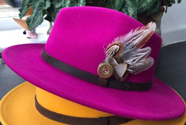 WhatsApp Image 2021 01 29 at 09.12.48 Fuscia wool felt fedora hat with feather pin. My wool felt fedora hats are beautifully made, water resistant & come complete with a detachable natural game feather pin. Available in sizes; Extra small 53-54cm,  Small 55-56cm & Medium 57-59cm The fedora hat is made from 100% wool felt and suitable to be worn in all weathers.  If the hat does get wet just leave it to dry flat & naturally.