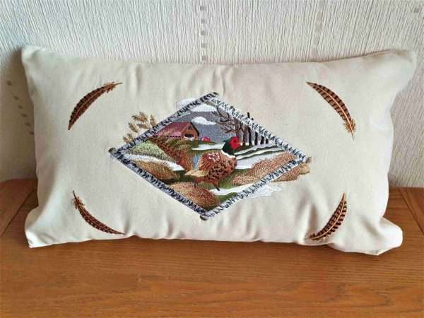 20210131 142809 scaled Very detailed embroidered Pheasant & Country Scene Cushion Cover available on Natural or Black Canvas. As you can see from the images the embroidery is of the best quality and has over 80,000 stitches in it. This design can be embroidered onto other items such as Hoodies, canvas bags, jackets and throws etc Natural canvas cushion cover. The rectangular shape creates interest in the lounge and bedroom and is a neat addition to home furnishings where the natural fabric sits happily with different textures and colour. <strong>The Cushion cover is 20"x 11"</strong> As all products are made to order please allow 7 working days for delivery. If you require anything urgently please ask as we may be able reduce our production times.