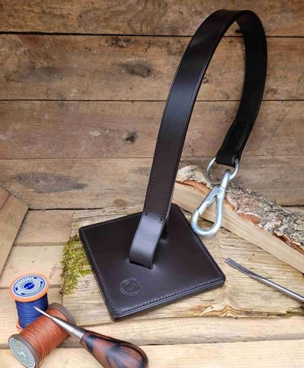 20230319 161633 scaled The magic of The Easy Saddle Hanger is that it is an original design by RSO Leather. Its handmade and handstitched using British bridle leather, making it both a practical and durable addition to your tack box. Its super handy when you need to tack up your horse when you're out and about on your own. <div class="o9v6fnle cxmmr5t8 oygrvhab hcukyx3x c1et5uql ii04i59q"> <ul> <li>- Perfect to use whilst tacking up instead of putting saddle on stable door or leaning against a wall.</li> </ul> </div> <div class="o9v6fnle cxmmr5t8 oygrvhab hcukyx3x c1et5uql ii04i59q"> <ul> <li>- Saves space in the tack room or narrow walkways as it doesn't stick out.</li> </ul> </div> <div class="o9v6fnle cxmmr5t8 oygrvhab hcukyx3x c1et5uql ii04i59q"> <ul> <li>- Really handy when competing or clinics/lessons, especially if you are on your own.</li> </ul> </div> <div class="o9v6fnle cxmmr5t8 oygrvhab hcukyx3x c1et5uql ii04i59q"> <ul> <li>- It takes up no space at all in horsebox or trailer.</li> </ul> </div> <div class="o9v6fnle cxmmr5t8 oygrvhab hcukyx3x c1et5uql ii04i59q"> <ul> <li>- Perfect for saddle stockists/saddle fitters to display saddles in tack shops or at events.</li> </ul> </div> <div class="o9v6fnle cxmmr5t8 oygrvhab hcukyx3x c1et5uql ii04i59q"> <ul> <li>- The strap is long enough for 18" saddles, dressage, jump or GP, easily clips onto tie rings.</li> </ul> For the full range of all the gorgeous hand made leather gifts, please check out the RSO Leather website at www.rsoleather.com </div>