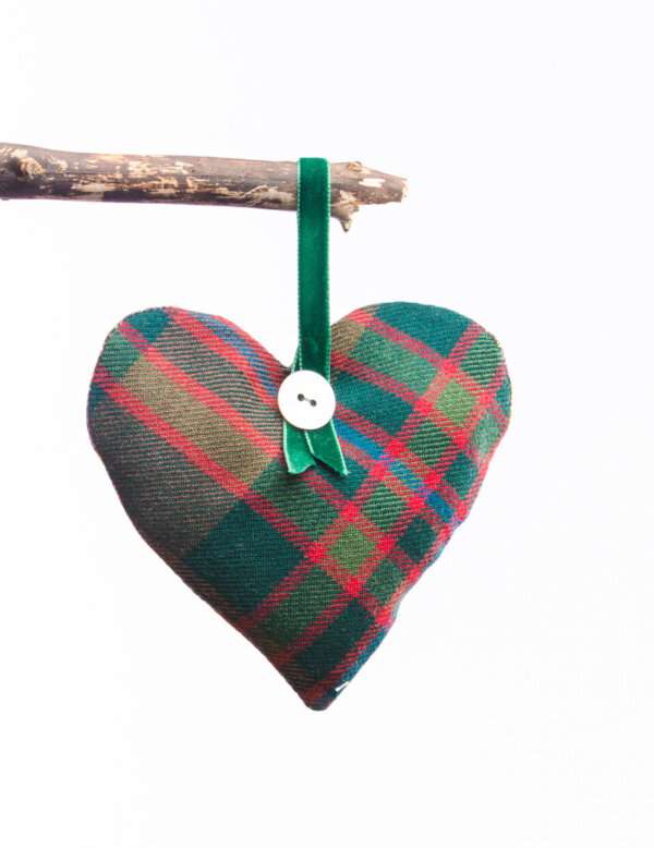 LoullyMakes Xmas produts 72 scaled e1612642846723 Gorgeous hanging heart-shaped herb pillow, lovingly handmade in our own exclusive John Muir Way tartan. These scented sachets are backed with a beautiful Liberty Art Fabric and finished with a velvet ribbon loop and decorative button - so can be hung from coat hangers, drawer handles, bedsteads , coat hooks, Christmas Trees, anywhere you like really. Each heart is filled with my own recipe of dried lavender , chamomile and hops - a combination which acts as a relaxing fragrance in the home. Enliven the scent occasionally by shaking the mix inside the heart, or place near a warm radiator for a fragrance boost . If hung near wardrobes, closets or drawers, this scented herb mix will also keep moths away from your favourite linens and garments ! NB DO NOT PLACE NEAR ANY NAKED FLAME OR DIRECT HEAT SOURCE. All tartans are 100% wool kiltweight woven tartans. Each tartan heart will be backed with a co-ordinating printed tana lawn cotton, which may vary from that pictured.