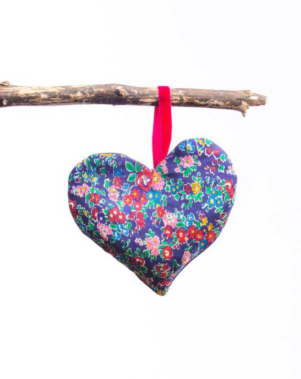 LoullyMakes Xmas produts 77 scaled e1612644964111 Gorgeous hanging heart-shaped herb pillow, lovingly handmade in our own exclusive Flodden Commemorative tartan. These scented sachets are backed with a beautiful Liberty Art Fabric and finished with a velvet ribbon loop and decorative button - so can be hung from coat hangers, drawer handles, bedsteads , coat hooks, Christmas Trees, anywhere you like really. Each heart is filled with my own recipe of dried lavender , chamomile and hops - a combination which acts as a relaxing fragrance in the home. Enliven the scent occasionally by shaking the mix inside the heart, or place near a warm radiator for a fragrance boost . If hung near wardrobes, closets or drawers, this scented herb mix will also keep moths away from your favourite linens and garments ! NB DO NOT PLACE NEAR ANY NAKED FLAME OR DIRECT HEAT SOURCE. All tartans are 100% wool kiltweight woven tartans. Each tartan heart will be backed with a co-ordinating printed tana lawn cotton, which may vary from that pictured.