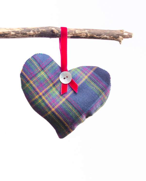 LoullyMakes Xmas produts 78 scaled e1612644921775 Gorgeous hanging heart-shaped herb pillow, lovingly handmade in our own exclusive Flodden Commemorative tartan. These scented sachets are backed with a beautiful Liberty Art Fabric and finished with a velvet ribbon loop and decorative button - so can be hung from coat hangers, drawer handles, bedsteads , coat hooks, Christmas Trees, anywhere you like really. Each heart is filled with my own recipe of dried lavender , chamomile and hops - a combination which acts as a relaxing fragrance in the home. Enliven the scent occasionally by shaking the mix inside the heart, or place near a warm radiator for a fragrance boost . If hung near wardrobes, closets or drawers, this scented herb mix will also keep moths away from your favourite linens and garments ! NB DO NOT PLACE NEAR ANY NAKED FLAME OR DIRECT HEAT SOURCE. All tartans are 100% wool kiltweight woven tartans. Each tartan heart will be backed with a co-ordinating printed tana lawn cotton, which may vary from that pictured.