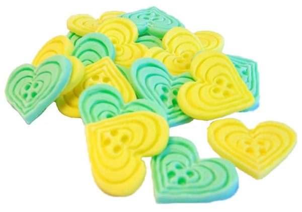 Inked18 Green yellow Buttons1jpeg LI If you’re looking for colourful edible heart shaped buttons to decorate your cupcakes and cakes then these are ideal for all your special occasions. Offering a choice of many single and mixed colours that are sure to please. Note: we also have square shaped buttons in same colours for those who would like to have a mix of each. 18 Heart Shaped Buttons Approx Size: 20mm high - 20mm wide