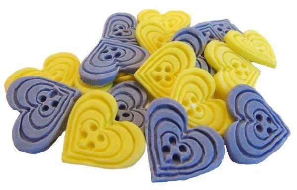 Inked18 Purple yellow buttonsjpeg LI If you’re looking for colourful edible heart shaped buttons to decorate your cupcakes and cakes then these are ideal for all your special occasions. Offering a choice of many single and mixed colours that are sure to please. Note: we also have square shaped buttons in same colours for those who would like to have a mix of each. 18 Heart Shaped Buttons Approx Size: 20mm high - 20mm wide