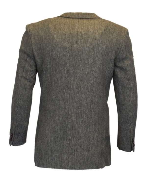 steel grey blazer back These world famous Harris Tweed jackets are superbly tailored, hard-wearing and warm. When purchasing one of these jackets you are guaranteed exceptional quality. By law Harris Tweed must come from the Outer Hebrides, and be hand woven from local wool. Supplied by Harris Tweed Scotland from 100% pure virgin wool, dyed, spun and finished in the Western Isles of Scotland. Expertly hand-woven by crofters in their own homes on the islands of Lewis, Harris, Uist and Barra. They are single breasted with two leather button fastening, and can be worn as a casual jacket or with a shirt and tie. Other specifications include side vents, two front pockets with flaps, Four interior pockets, three button leather cuff and Fully lined. Spare Button Leather buttons included. Dress with matching waistcoat for an extremely stylish look perfect for weddings and the races. All our tweeds are stamped with the authentic, official gold crossed orb mark of the Harris Tweed Authority.