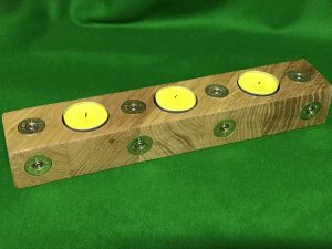 EC11C86F EA09 4715 9080 6A3D2BC05188 A beautiful bespoke solid oak tea light holder with brass shotgun cartridge ends inlaid to a flush finish coated with 2 coats of finishing oil to protect both the wood and the brass ends Please note the natural grain and colour of the wood will be different in every piece so each one will be unique