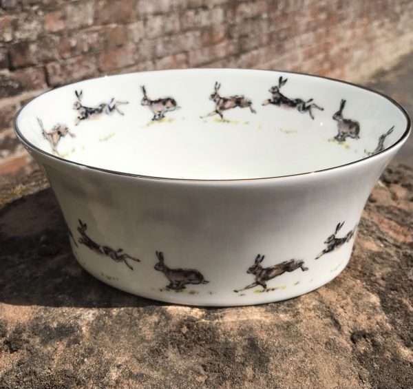 Hare Fussion Bowl Emma Wyatt Gifts. Hare Fusion Bowl. An English fine bone china Hand decorated oval dish with running hares around the outside and inside, edged in gold.  
