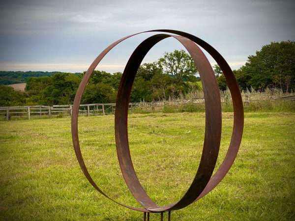 WELCOME TO THE RUSTIC GARDEN ART SHOP Here we have one of our. Rustic Metal Wide Garden Ring Hoop Sculpture - Pair of Rusty Ring Circle Garden Art / Globe / Sphere Interchangeable metal ring sculptures - one is slightly smaller so fits within the other ring with two stakes per ring. Enabling you to arrange your own formation or design. These two rustic garden rings make a unique, versatile garden sculpture. Arrange the rusty metal rings in any formation to create your very own unique piece of affordable garden decor. Our Rustic/Rusty patina gives a natural and unique finish, which will continue to better with age. Our rustic garden art products require absolutely no maintenance! Sizes & Measurements:
Medium - Approx 50cm diameter -made from flat steel 90mm wide