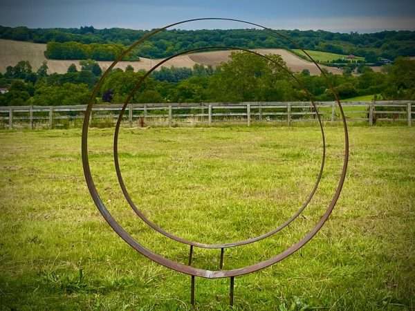 WELCOME TO THE RUSTIC GARDEN ART SHOP Here we have one of our. Rustic Metal Wide Garden Ring Hoop Sculpture - Pair of Rusty Ring Circle Garden Art / Globe / Sphere Interchangeable metal ring sculptures - one is slightly smaller so fits within the other ring with two stakes per ring. Enabling you to arrange your own formation or design. These two rustic garden rings make a unique, versatile garden sculpture. Arrange the rusty metal rings in any formation to create your very own unique piece of affordable garden decor. Our Rustic/Rusty patina gives a natural and unique finish, which will continue to better with age. Our rustic garden art products require absolutely no maintenance! Sizes & Measurements:
Medium - Approx 50cm diameter -made from flat steel 90mm wide