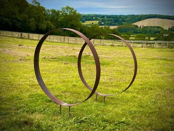 WELCOME TO THE RUSTIC GARDEN ART SHOP Here we have one of our. Rustic Metal Wide Garden Ring Hoop Sculpture - Pair of Rusty Ring Circle Garden Art / Globe / Sphere Interchangeable metal ring sculptures - one is slightly smaller so fits within the other ring with two stakes per ring. Enabling you to arrange your own formation or design. These two rustic garden rings make a unique, versatile garden sculpture. Arrange the rusty metal rings in any formation to create your very own unique piece of affordable garden decor. Our Rustic/Rusty patina gives a natural and unique finish, which will continue to better with age. Our rustic garden art products require absolutely no maintenance! Sizes & Measurements:
Large - Approx 100cm diameter -made from flat steel 90mm wide