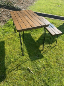 download 19 Solid Wood Rustic Outdoor Garden Patio Dining / Restaurant / Bistro / Cafe / Bar Table Extra Chunky Reclaimed timber style 67cm wide x a range of lengths up to 140cm Solid wood tabletop and hairpin legs Matching Benches available Please check our or shop If you cant see the size you are after please message us as we are more than happy to create custom sizes for you. **FREE DELIVERY** Please Note: The tabletops are sent out by a secure service via DX Express and the Legs should arrive the same day via DPD Black Powder Coated steel hairpin legs Handmade from environmentally reclaimed pine timber and finished buy hand in our workshops in the heart of the New Forest Please note that due to the rustic design and style of the piece that the wood will take the stain differently in each piece Kind Regards Ben and Esther at New Forest Countryside *****PLEASE NOTE DUE TO TIMBER SHORTAGES IN THE UK SOME DELIVERIES MAY BE SLIGHTLY DELAYED, WE WILL ENDEAVOR TO KEEP THIS TO A MINIMUM WHILST PROVIDING THE SAME GREAT VALUE TO OUR CUSTOMERS. MANY THANKS THE NFC TEAM******