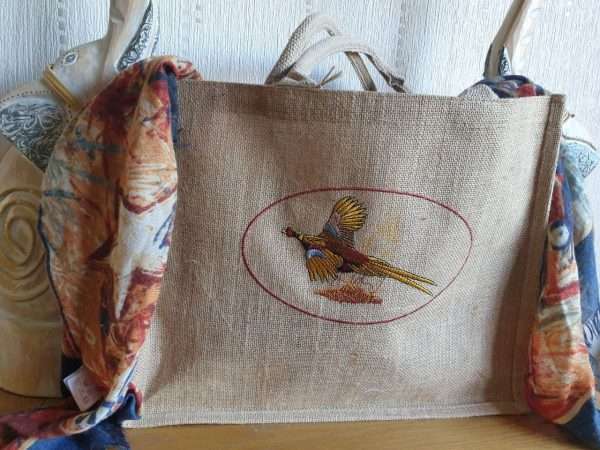 photo 2022 09 25 18 29 14 Pheasant Embroidered Jute Shopping Bag Large Size. FREE Personalisation. These bags are embroidered and not printed. The embroidery will not fade and will last the life time of the bag. The embroidery is individually done and can take up to 7 working days to complete. If you require something urgent please let me know as I may be able to get it done quickly for you. Available in 7 Colours - Laminated Jute Bag Dimensions 42 x 33 x 19cm Handle length - 55cm. Cotton carry handles Sponge clean only<img class="alignnone size-medium wp-image-185969" src="https://www.thecountrysidestore.co.uk/wp-content/uploads/2022/09/photo_2022-09-25_18-29-14-300x225.jpg" alt="" width="300" height="225" />