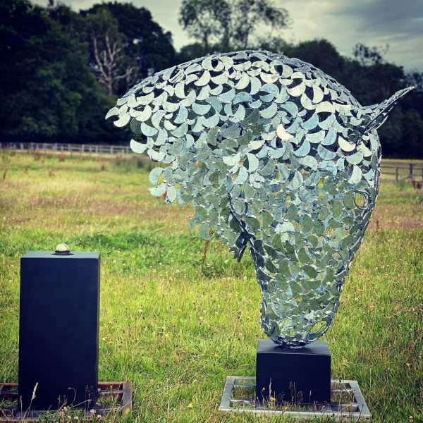 0C48D4F9 7B42 44A4 9D63 4CE583B1AAD6 4 Metre Horse Head Equine Sculpture by British Sculptor Charles Elliott - Handcrafted using plate steel shapes Finished in a luxurious zinc galvanise to last a lifetime, mounted on a black steel plinth. Illumination kits availvale for this scuplture.   Sitting at a total height of 4 metres. A choice of plinths finished in a colour to suit.   Horse Head Sculpture Sizes Prices: 6m - £POA +VAT 4m - £POA +VAT 2m - £11500 +VAT 1.2m - £8000 +VAT   All Enquiries Welcome Worldwide Shipping & Installation Available   We Welcome Studio Visits - By Appointment Only www.elliottoflondon.co.uk info@elliottoflondon.co.uk 01494 758 896