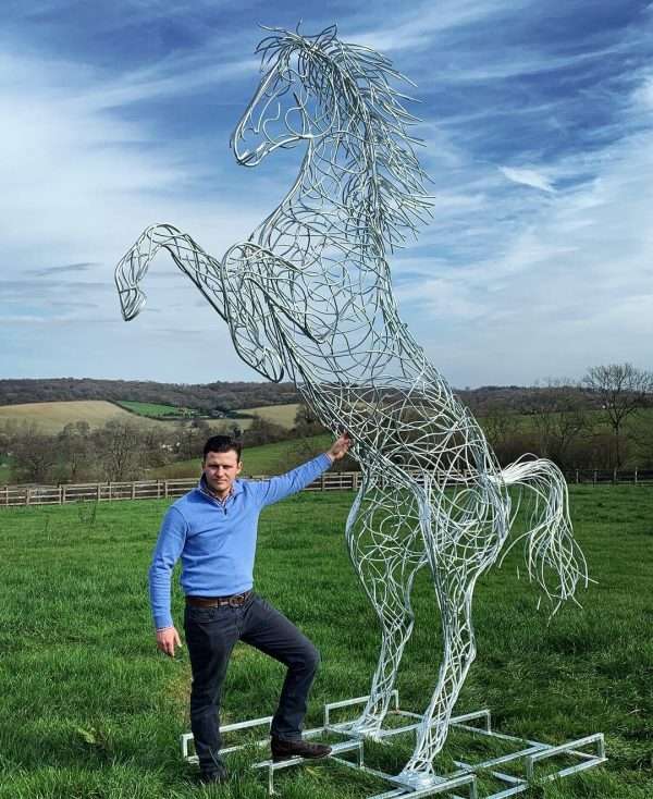 13 ft Rearing Horse Sculpture Main SOLD* ALL COMMISSIONS & ORDERS WELCOME * Our NEW 13 foot Rearing Horse Sculpture By British Sculptor Charles Elliott, Internationally Renown for his Unique Equestrian Sculptures - This Handcrafted Life Size Rearing Horse Sculpture forms the latest one off sculpture of The Elliott of London Equestrian Sculpture Range. Their NEW Equestrian Sculptures are inspired by Charles’s families and own love of horses, each Sculpture in the range is completely unique and built by hand in Hertfordshire. Their NEW Horse Sculptures can been seen online at www.elliottoflondon.co.uk or at their Sculpture Studio in Berkhamsted, HP4 3GW. Charles works closely with his team at their studio to put together ideas, designs and build these one off unique equestrian sculptures. Handmade from 8mm round mild steel to indicate power and flow, luxurious progressive zinc exterior galvanised finish to protect the piece from nature and rust for over 30 years! Delivery and Installation Services Available - Worldwide Shipping and International Delivery Available! All Enquiries Welcome - Available to Buy, as well as long term and short term hire!   Approx Dimensions: H 395cm (13ft) W 300cm (10ft) D 85cm (3ft)   Studio Office - 01494758896 Charles - 07591730415 Website: www.elliottoflondon.co.uk Email:info@elliottoflondon.co.uk Viewing Welcome by Appointment only