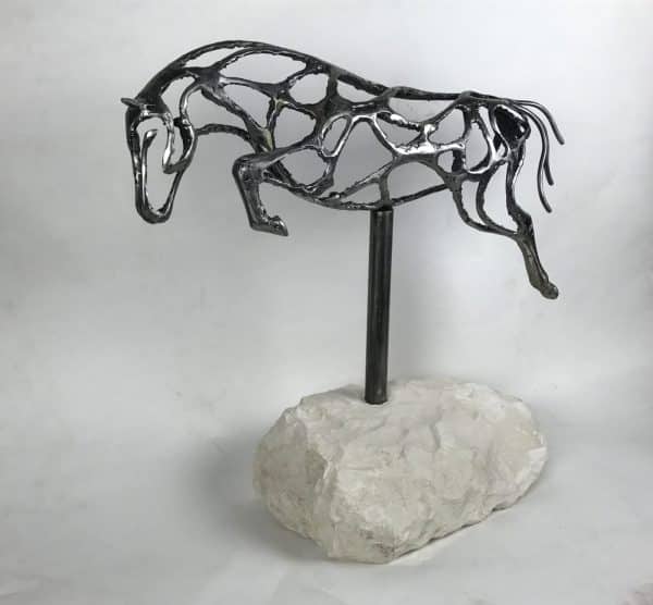 ABSTRACT JUMPING HORSE SCULPTURE Gallery 1 Elliott of London Abstract Jumping Horse Limited Edition 1 of 1 One-Off Sculpture Handcrafted Abstract Jumping Horse Sculpture by British Sculptor Charles Elliott   This piece is suitable for a table feature or interior ornament. In a rugged texture mild Steel with a interior gloss finish.   Handmade in Buckinghamshire. Overall Dimensions: 54cm Long 52cm Height 22cm Width   Limited Edition - 1 of 1- One- Off Sculpture   Worldwide Shipping Available! All Commissions Welcome www.elliottoflondon.co.uk info@elliottoflondon.co.uk