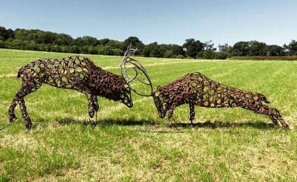 Fighting Stags Sculpture Main SOLD Limited Edition 1 of 1 One-Off Sculpture Similar available to order - 'Fighting Stags' Full Size Handmade Bespoke Sculpture Two large full size stags fighting, handmade from Upcycled horse shoes - One of a kind, all handmade and bespoke! Designed and Made by Artist Charles Elliott   Approximate Dimensions - Length 5.2 m Width 0.75m Height 1.5 m All supports will be cut off and the sculpture is to be fitted 100mm below ground level, pictures do the sculpture no real justice! Viewing Welcome Anytime -   Delivery and Installation Services Available Worldwide Shipping Available! All Commissions Welcome www.elliottoflondon.co.uk info@elliottoflondon.co.uk