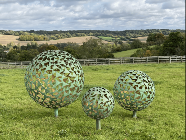 IMG 4382.HEIC Trio of Sphere Sculpture Our NEW Trio of Sphere Sculpture, three different size spheres arranged in a triangular layout, these spheres together can create that huge wow factor to your outdoor or indoor space. Our spheres are also available individually, please see our shop. We are able to offer all our sphere styles & finishes in this trio of sphere sculpture.   This selection of spheres displayed here are our Verdigris & Gold 1.5m, 1m & 65cm - Prices may vary, dependant on the sizes you choose, also styles and finishes can affect costs.   *Additional Charges for Installation, Delivery & Illumination Kits Available On Request.   Our Verdigris & Gold Spheres Handmade in Buckinghamshire Designed and Handcrafted by Elliott of London from mild steel with a luxurious progressive Verdigris Aged Bronze Exterior and glowing Gold gilt Interior. This piece is hot zinc galvanised initially to secure and protect the piece from nature and rust for over 30 years. "Each sail piece individually textured and finished with a luxurious patina by hand!" Designer Charles. Inspired by nature, with weather aged Patina on the outside with new bright gold on the inside.It can be used as a garden vocal point or also as an interior piece, it can be scaled down accordingly and illuminated internally. Available floating above ground level or raised on a choice of stone plinths. Illumination Kits available. Alternative sizes and alternative finished plinths are available at additional costing - please call for more information.   All Enquiries Welcome Worldwide Shipping & Installation Available   We Welcome Studio Visits - By Appointment Only www.elliottoflondon.co.uk info@elliottoflondon.co.uk 01494 758 896