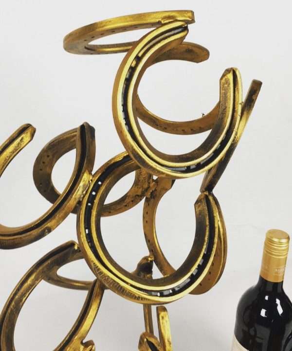 download 64 Handmade Wine Rack Made from horseshoes Holds 6 bottles of wine. Ideal as a display piece within a kitchen or dinning area.   Standard or Limited Edition Black & Gold Patina   Wine NOT included unless option is selected   Each Item is made to order. Other Finishes Available on request Worldwide Shipping Available! All Commissions Welcome www.elliottoflondon.co.uk info@elliottoflondon.co.uk