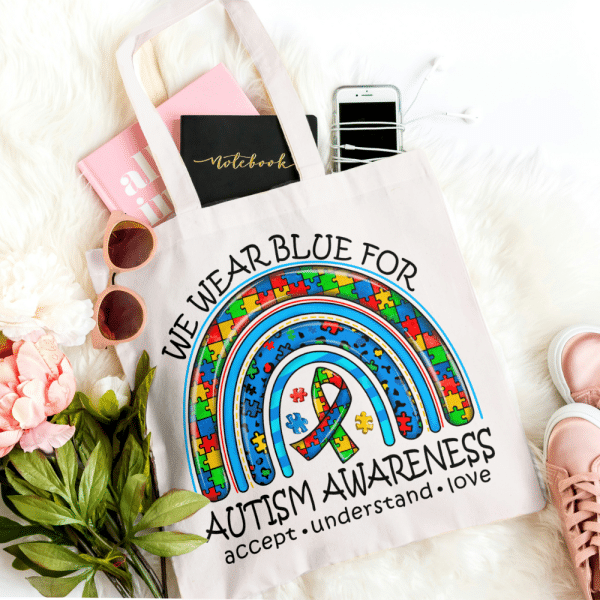 Autism Awareness bag Our Autism Tote Bag is made from high-quality materials, ensuring durability and longevity. It features a Direct-to-Fabric (DTF) print, a cutting-edge printing technology that ensures vibrant colours and sharp details. The print showcases the phrase "We Wear Blue for Autism", written in an elegant font that adds to the overall aesthetic appeal of the bag. The blue colour represents the global symbol for autism awareness, making this tote bag an emblem of support and advocacy.